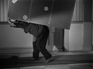 Idle Roomers - Curly as the bellhop carrying the heavy luggage in the Three Stooges short film