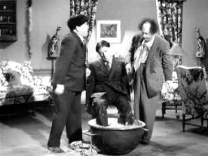 Moe and Larry put Shemp's feet in cement
