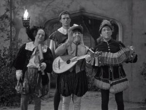 Larry, Moe, and Shemp helping their blacksmith friend (Jock Mahoney) serenade the princess