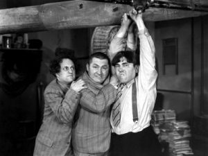 The Three Stooges (Moe Howard, Larry Fine, Curly Howard) as inept plumbers in a scene from their short film A-Plumbing We Will Go (1940).